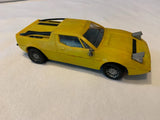 Yellow plastic model car with open hood and black details
