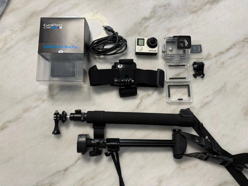 GoPro HERO4 action camera bundle with mounts, handle, pole, waterproof housing, and accessories