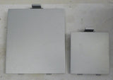 Two square gray plastic covers with small latch tabs