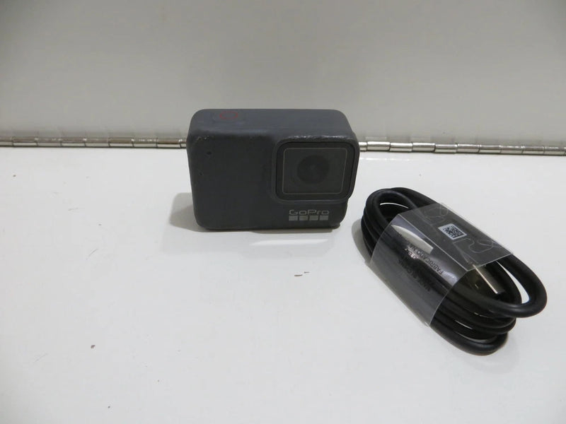 GoPro HERO7 action camera with front lens and coiled black cable