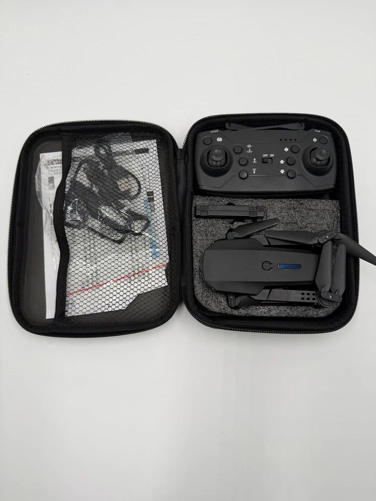 Foldable FPV quadcopter drone and remote controller in open carrying case