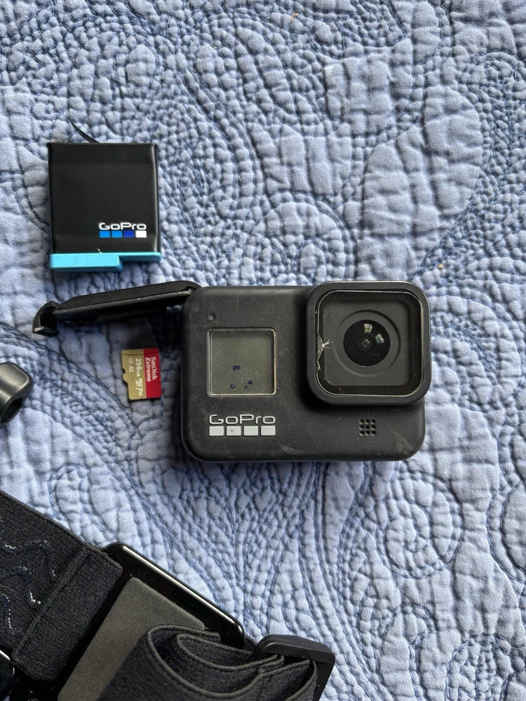 Black GoPro action camera with rear screen, front lens, and head mount strap