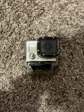 Silver action camera in clear case, front lens and HERO logo visible