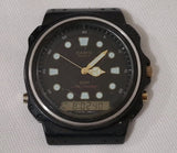 Casio AQ-100W diver watch with black dial, gold-tone hands, digital display, rubber strap