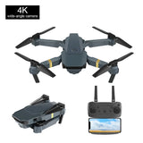 Foldable quadcopter drone with 4 propellers and camera, plus handheld remote controller