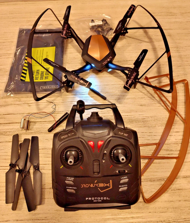 Quadcopter drone with four propellers and remote controller, including landing gear
