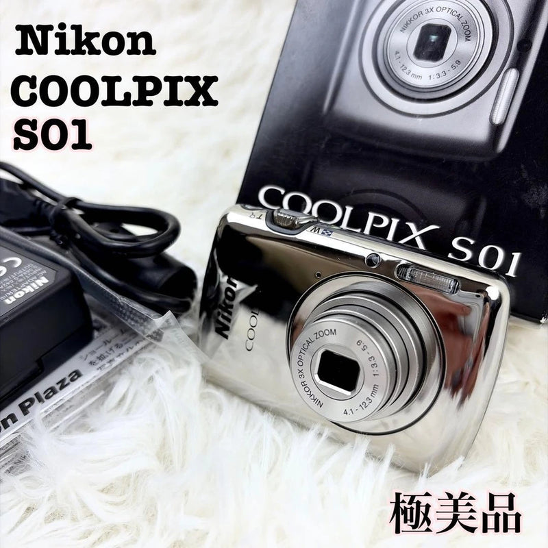 Black Nikon COOLPIX S01 compact camera with front lens and chrome control dial