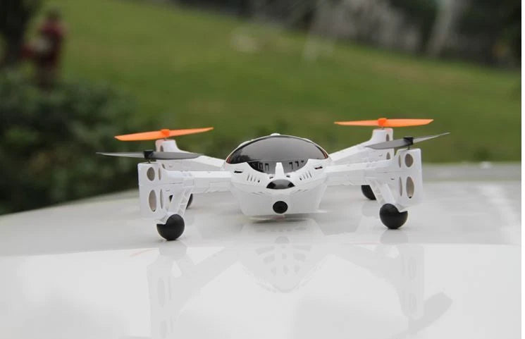 Walkera QR W100 drone with camera: white quadcopter with orange propellers and front camera lens.