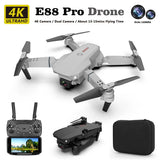 Gray quadcopter drone with built-in camera and four foldable propellers