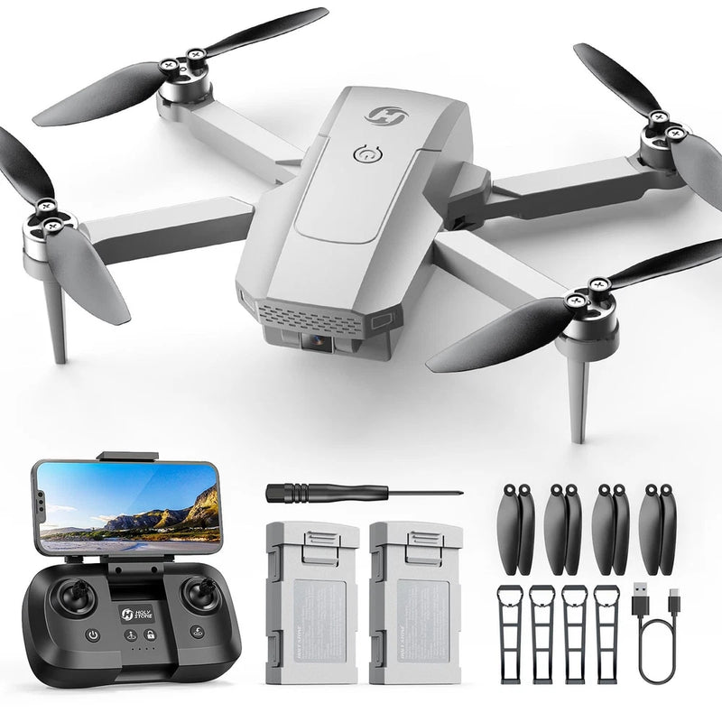 Gray quadcopter drone with remote controller, extra batteries and propellers kit