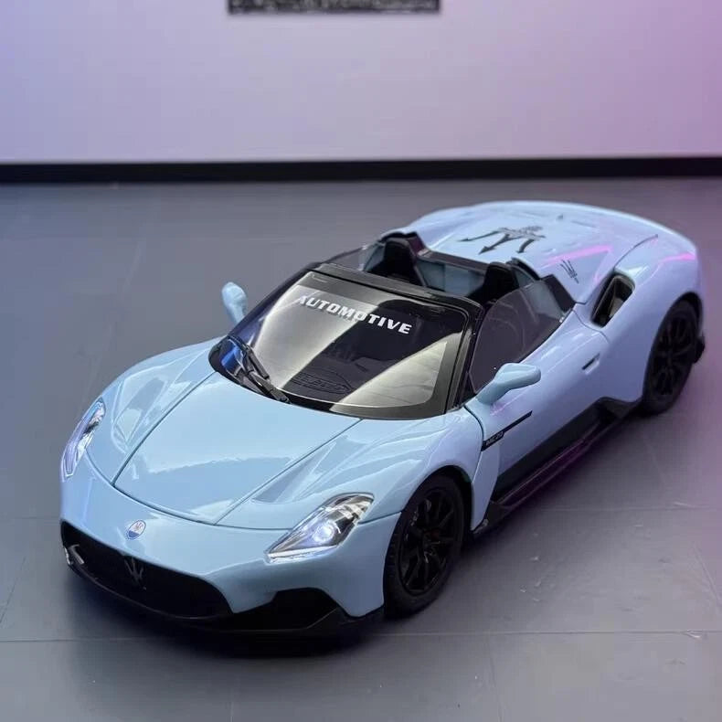Maserati MC20 alloy sports car model, light blue with black wheels and trim (1:24)