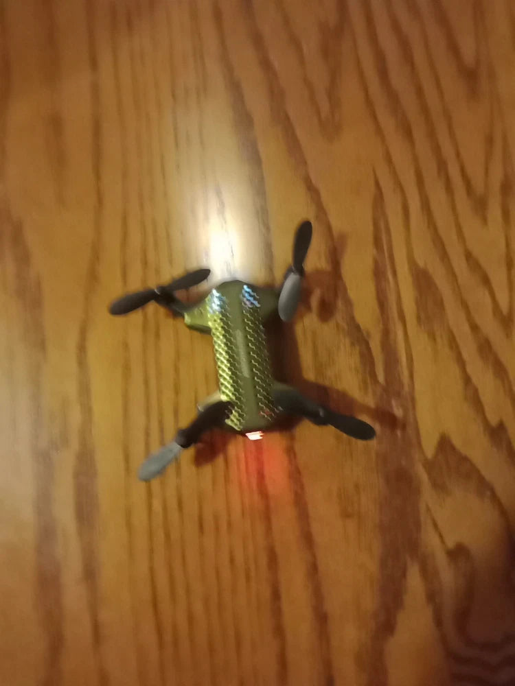 Ultra-compact folding micro drone, green body with four propellers