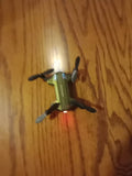 Ultra-compact folding micro drone, green body with four propellers