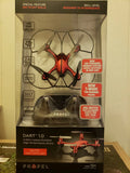 Red quadcopter drone in retail box, four propeller arms visible