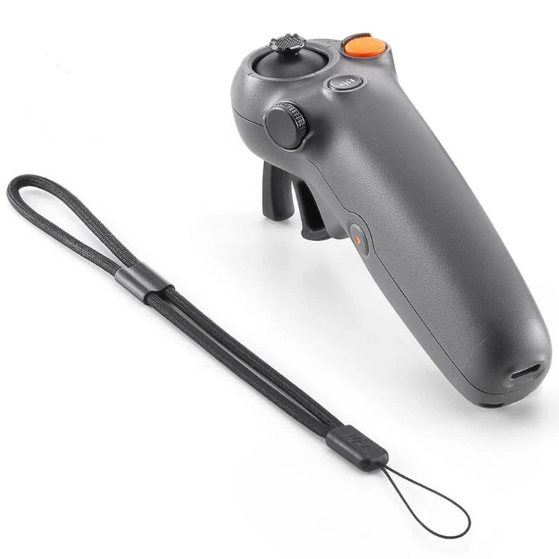 Handheld gray drone motion controller with wrist strap and orange button