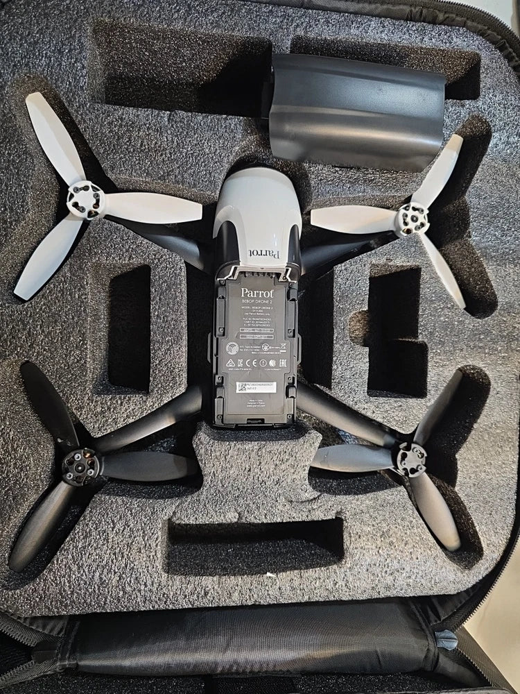 White Parrot Bebop drone with four black propellers in foam-lined case
