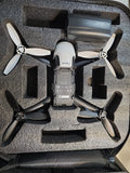 White Parrot Bebop drone with four black propellers in foam-lined case