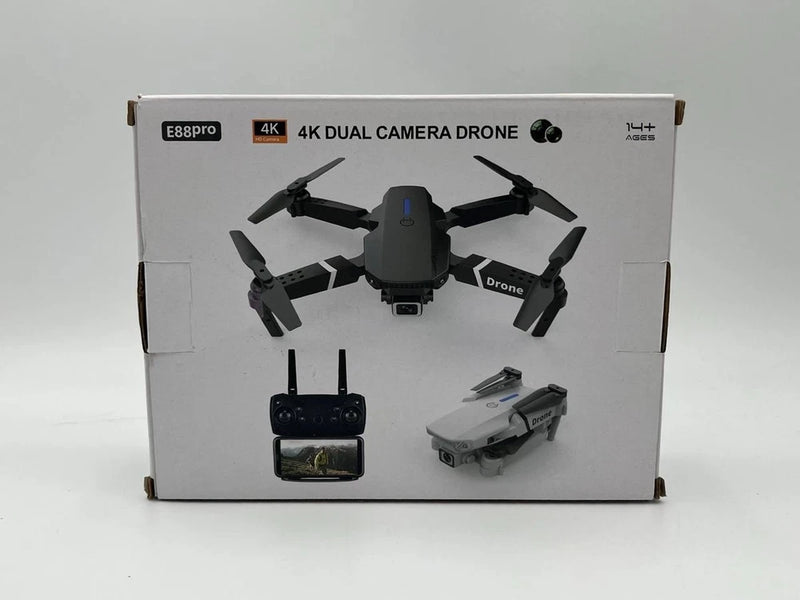 Foldable quadcopter drone with 4K dual camera, shown with remote controller in box