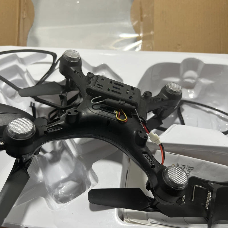 Black quadcopter drone with four propellers and central camera module