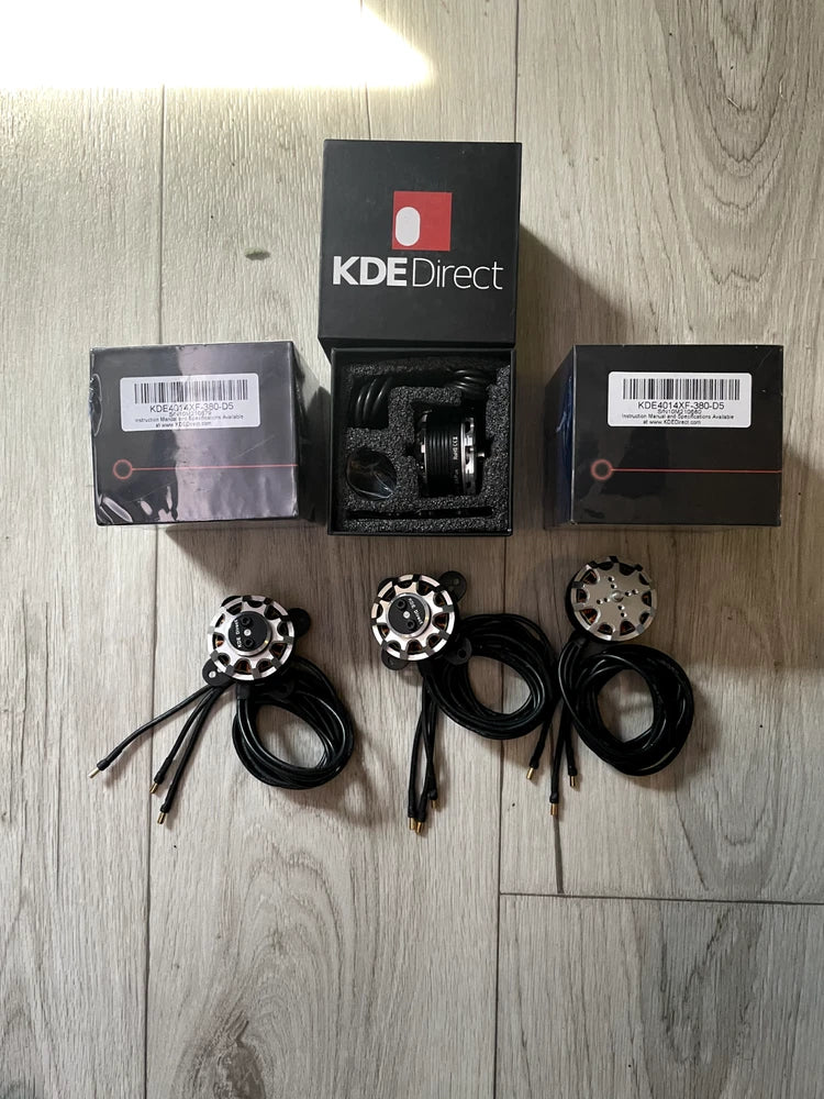 Set of 3 black drone motor housings with wiring and mounting hardware, in boxes