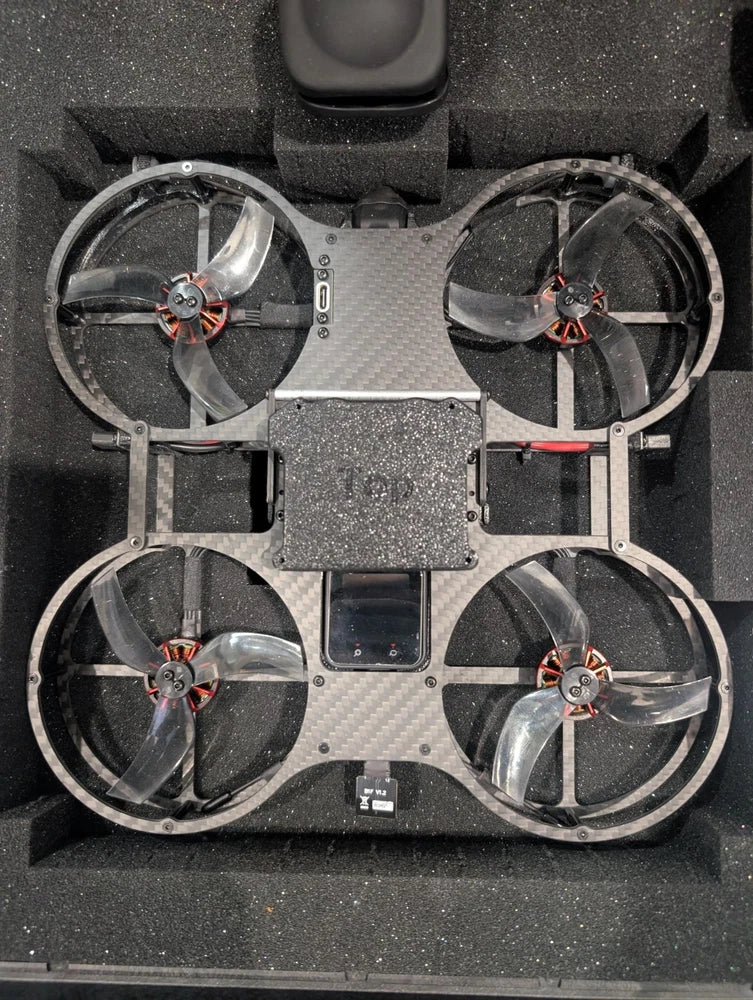 Quadcopter drone with four propellers in fitted foam case