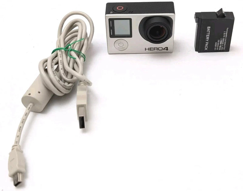 Silver action camera with front lens, LCD screen, and USB power cable attachment
