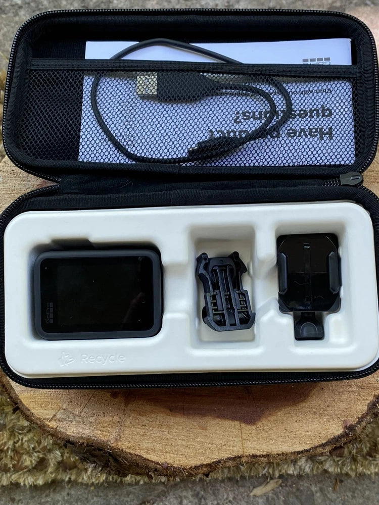 Black action camera case open with HERO10 camera and mounts, cables, and accessories
