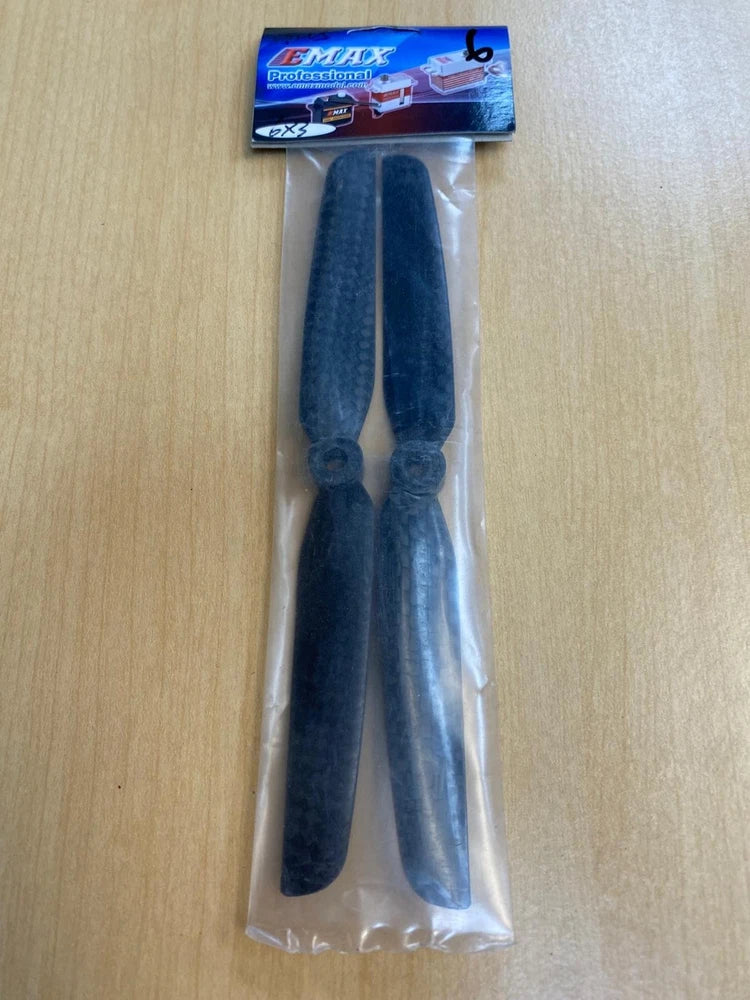 Carbon fiber drone propeller pair, dark blue, in clear plastic bag