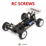 Black RC model car chassis with four wheels, viewed from above at an angle