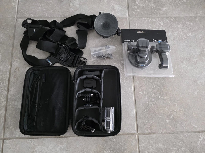 GoPro HERO3 action camera kit with waterproof case, mounts, and black straps