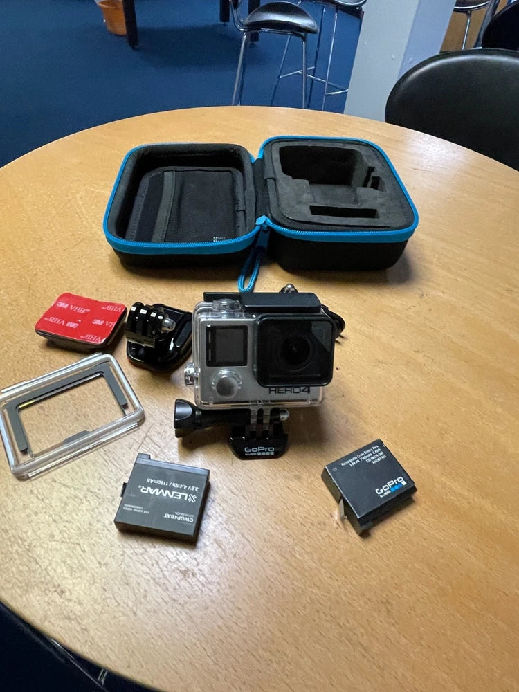 GoPro action camera kit with camera, waterproof case, mounts, and memory cards