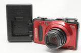Red Fujifilm FinePix F550EXR digital camera with Fujinon lens, rear LCD visible