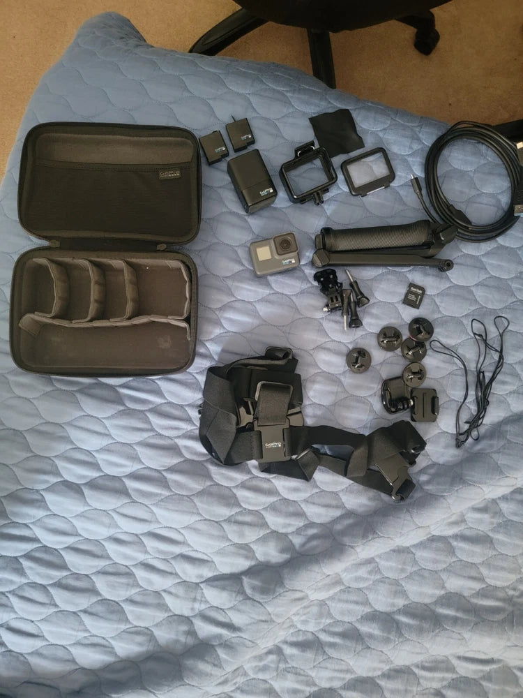 GoPro HERO6 action camera kit with open carry case, mounts, batteries, and accessories