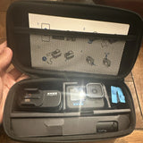 GoPro HERO10 action camera in open zip case with mount and cables