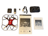 Red quadcopter drone with camera, propellers, and instruction booklets