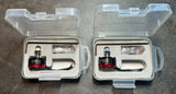 Pair of FPV brushless drone motors in clear plastic storage cases with wires