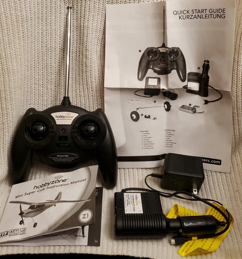 RC remote transmitter with two antennas, instruction manual, and AC charger set