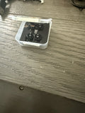 Mini quadcopter drone motor assembly in clear plastic case with four propellers