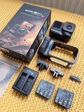 Dual battery grip bundle with action camera, two batteries, and charger mounts