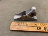 Metal block plane with wooden handle and front blade