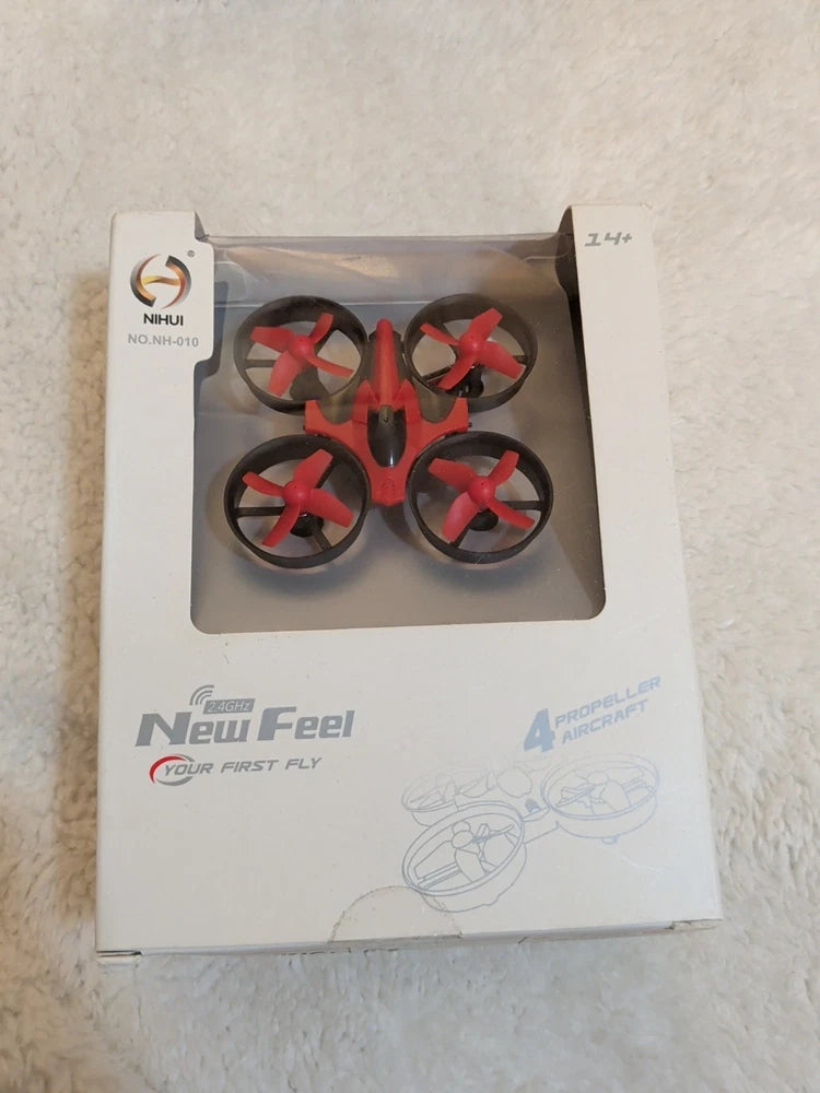 Mini toy quadcopter drone in box, red and black props, 4-blade design