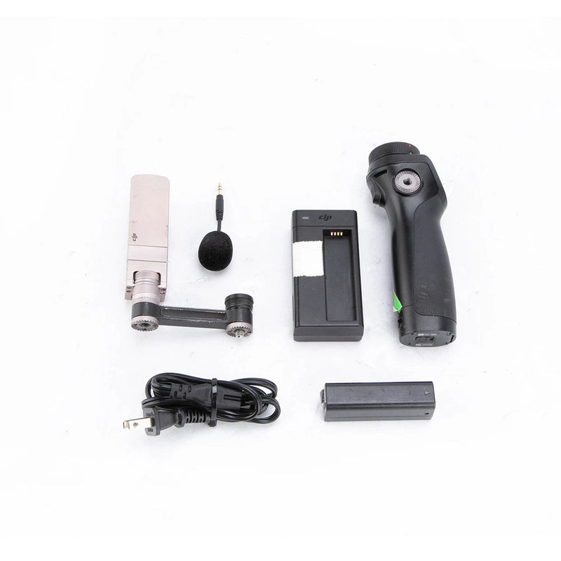 Handheld gimbal camera kit with black handle, phone mount, battery, charger, cables, mic
