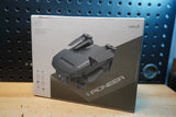 Black quadcopter drone shown on retail box, top view of 4-rotor frame