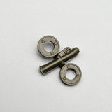 Metal model kit battery parts: two circular housings with tubing marked 85