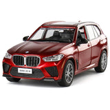 BMW X5 M diecast toy car, red metal, front three-quarter view with detailed grille