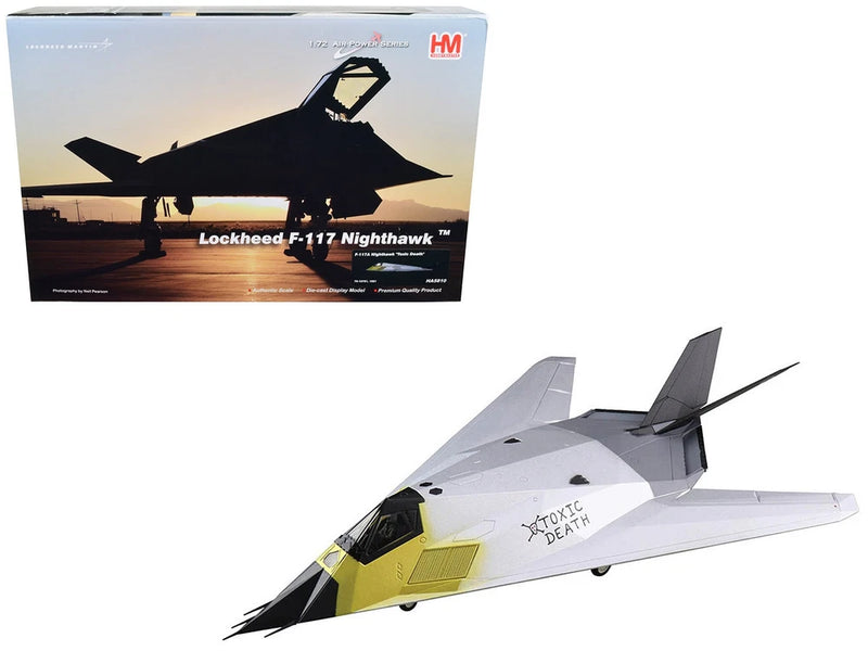 Gray and white stealth aircraft model with yellow panel, side view with wings and tail