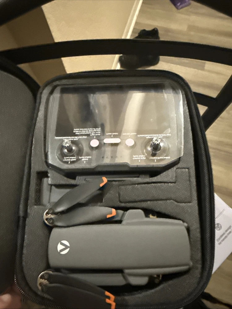 Foldable 4K video drone in molded protective carrying case with controller accessories