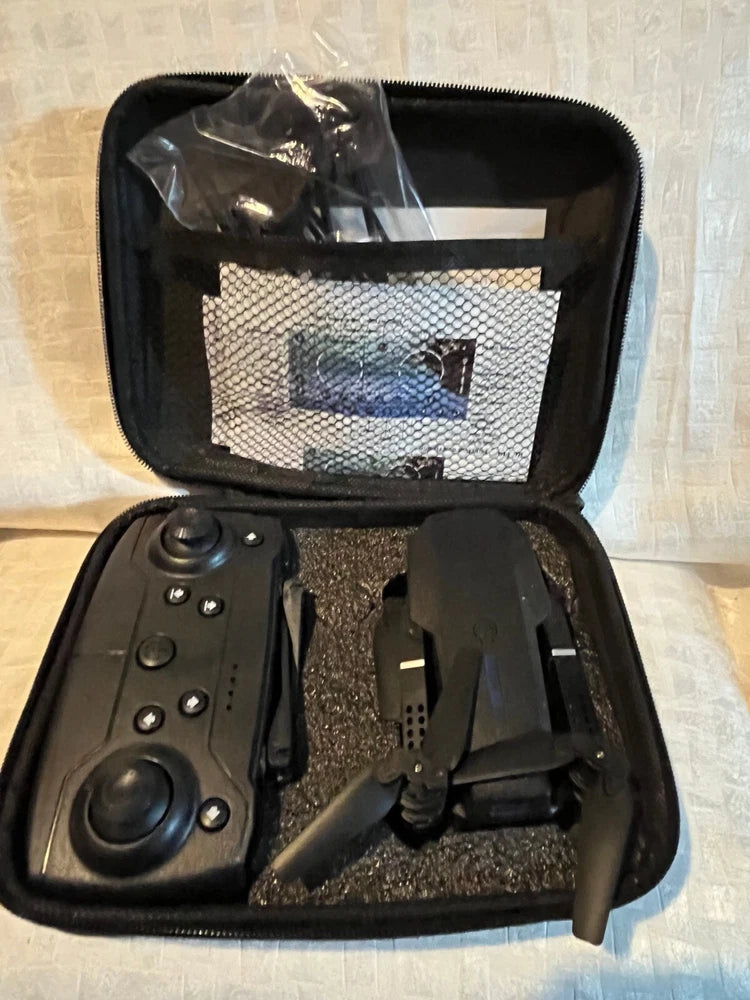 Foldable quadcopter drone kit with remote controller in black zippered carrying case