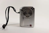 Fujifilm FinePix F601 Zoom digital camera, front view with lens and wrist strap