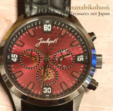 Men's analog model watch with round dark strap, red dial, gold markers and three subdials